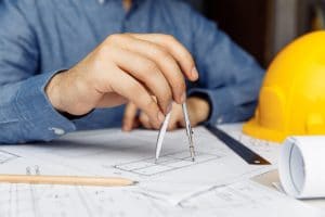 building-concept-civil-male-engineer-working-on-blueprint-architectural-project-at-desk-in-office